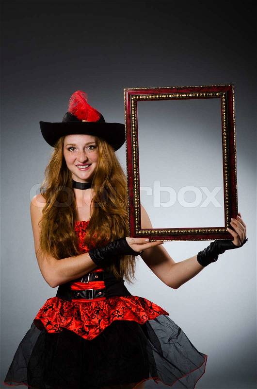 Woman pirate with picture frame, stock photo