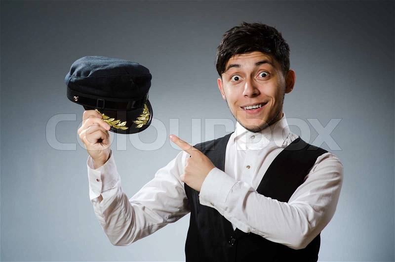 Funny taxi driver wearing peaked cap, stock photo