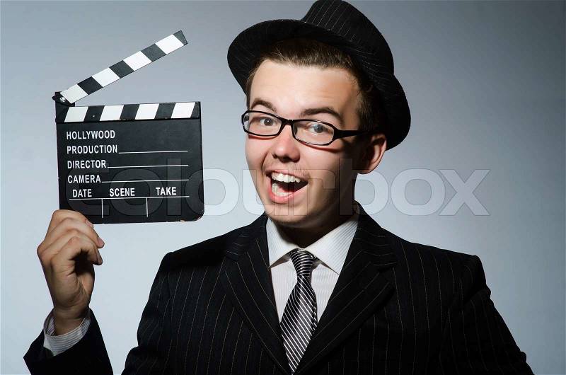 Man with movie clapperboard and hat, stock photo