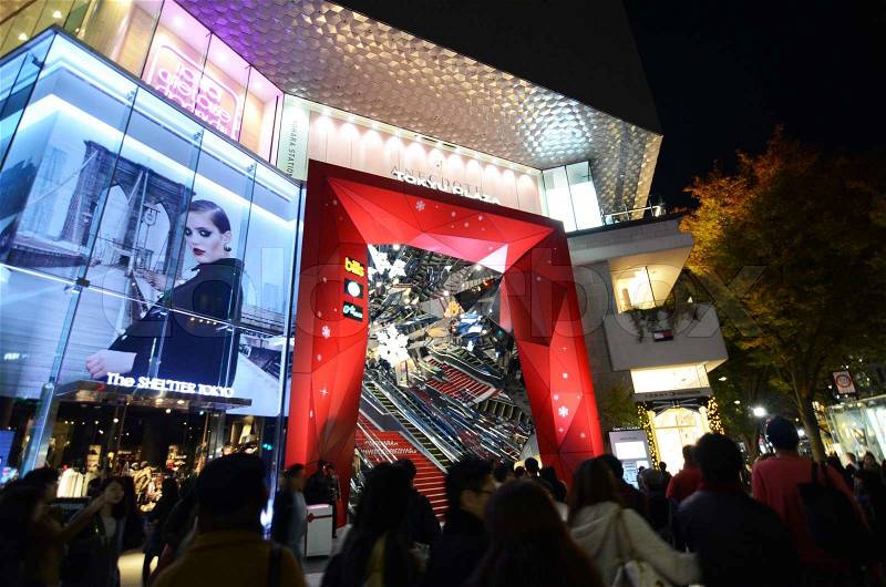 Tokyo, Japan - November 24, 2013: People shopping around Retail shops on Omotesando Street at night on November 24. 2013, Omotesando street sometimes referred to as Tokyo\'s Champs-Elysees. Here you can find famous brand name shops, cafes and restaurants f