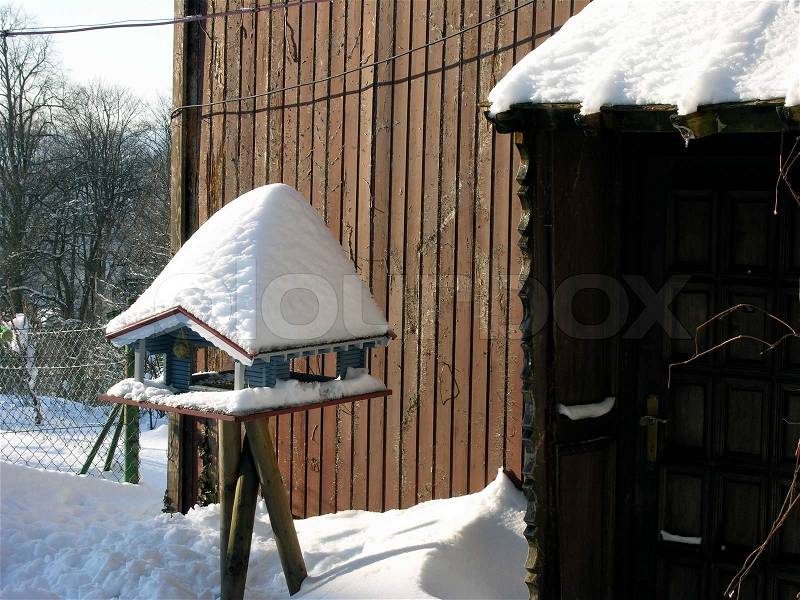 Bird feeding house and snow all over, stock photo