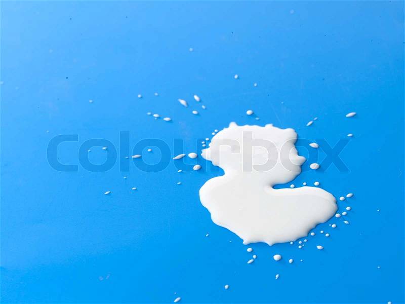 Spilled milk on the ground, stock photo