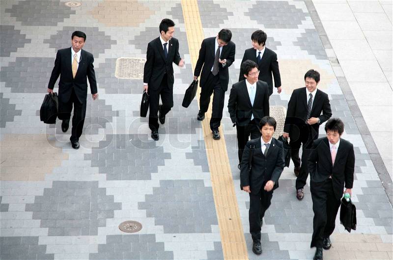 Street Scenes Tokyo Japan, business man and school boys, stock photo