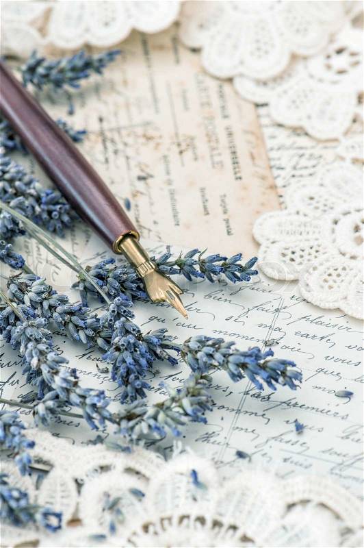 Vintage ink pen, dried lavender flowers and old love letters. retro style toned picture, stock photo