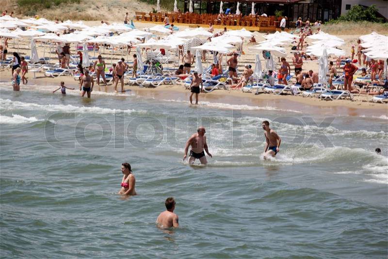 SUNNY BEACH, BULGARIA - JUNE 19: People visit Sunny Beach on June 19, 2014. Sunny Beach is the largest and most popular seaside beach resort in Bulgaria, stock photo