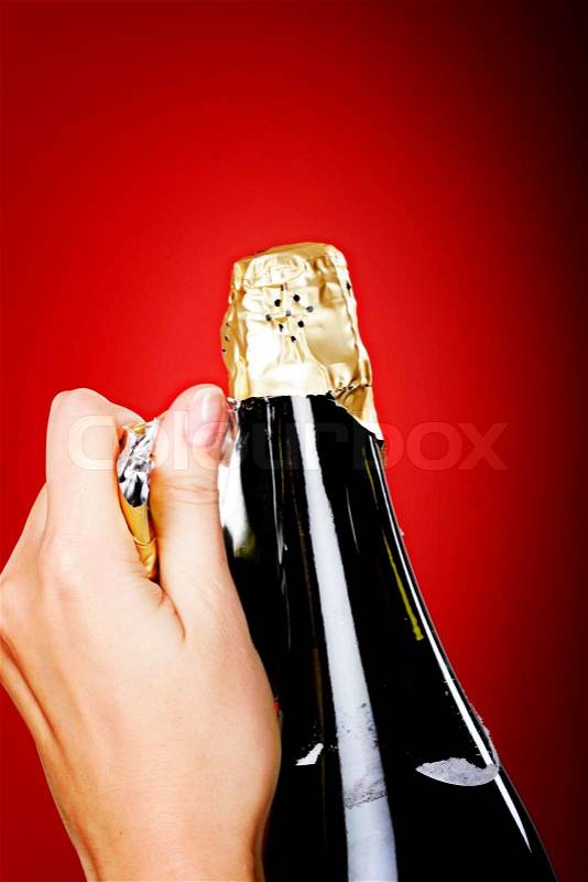 Woman hands opening champagne bottle, stock photo