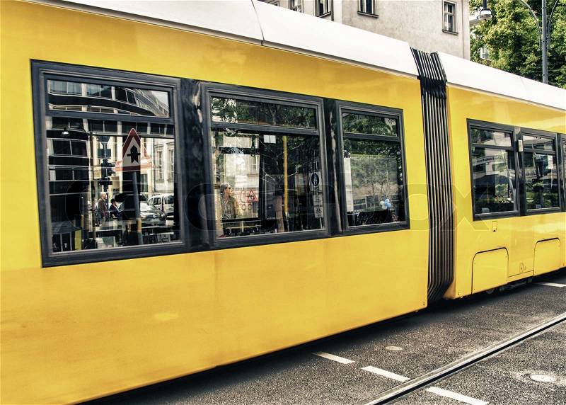 BERLIN - MAY 23, 2012: Yellow tram on city streets. The tram in Berlin is one of the oldest tram systems in the world, stock photo
