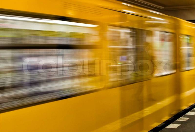 BERLIN - MAY 24, 2012: U-bahn train speeds up in subway station. The U-Bahn serves 170 stations spread across ten lines, stock photo