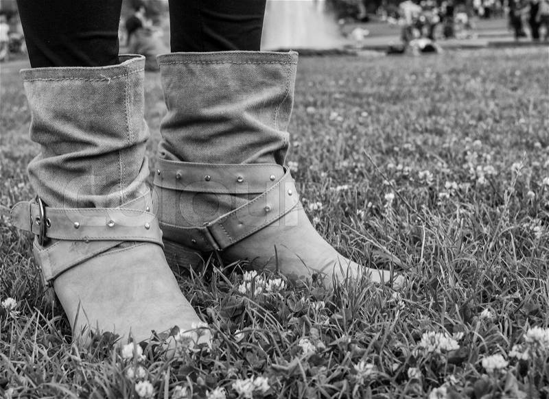 Woman boots on a green garden, stock photo