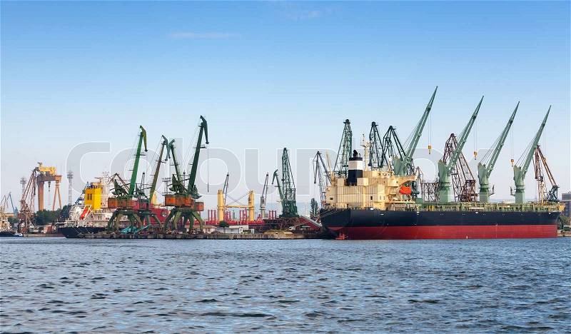 Industrial cargo ship is loading in port of Varna, Bulgaria, stock photo