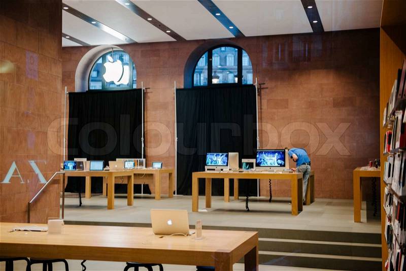 STRASBOURG, FRANCE - SEPTEMBER 18, 2014: Apple Store with working Apple Genius Employee and covered shopping windows with black fabric curtains to protect the store rearrangement for the iPhone 6 launch. Apple\'s redesigned iPhones with bigger screens goes