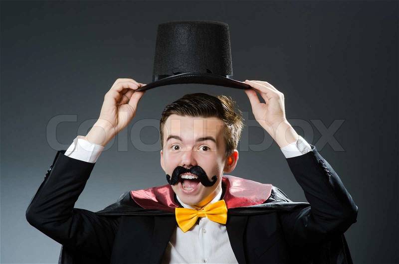 Funny magician with wand and hat, stock photo