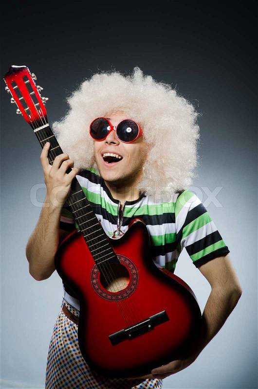 Man with funny haircut and guitar, stock photo