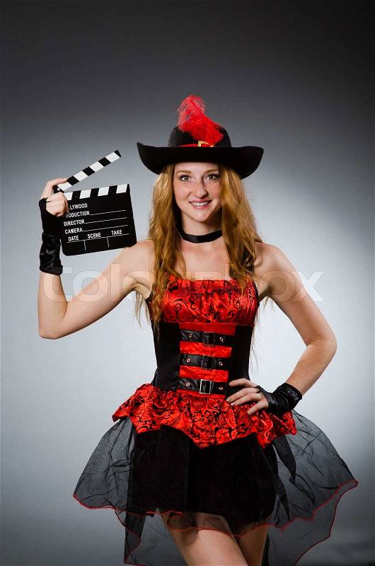Woman in pirate costume with movie board, stock photo