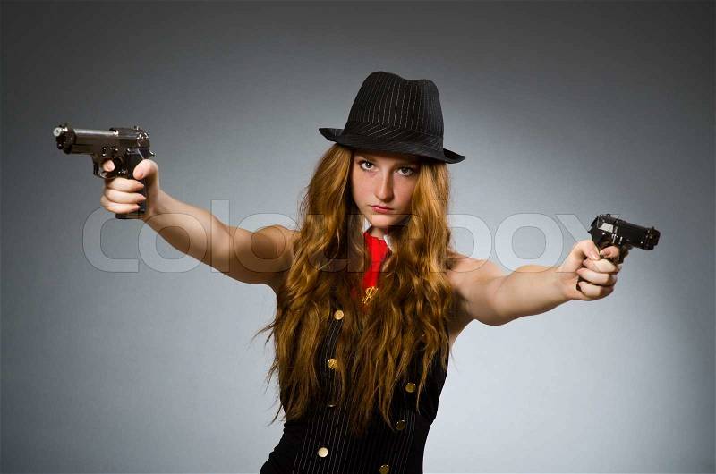 Woman gangster with gun in hand, stock photo