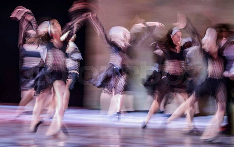 Group of contemporary dancers performing on stage, stock photo