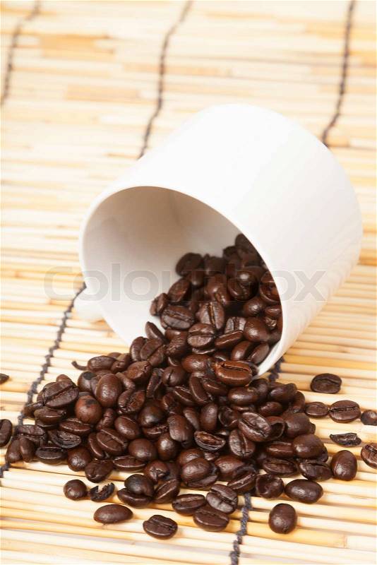 White coffee cup with coffee beans on table wooden, stock photo
