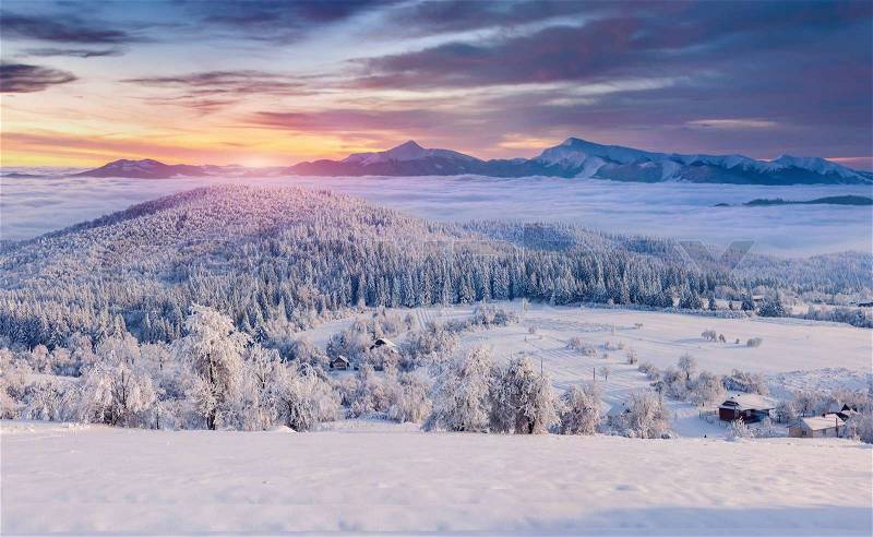 Panorama of the foggy winter sunrise in the mountain village, stock photo