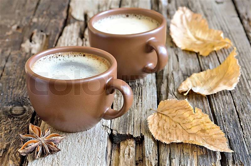 Coffee cup with cinnamon in an autumn morning, stock photo