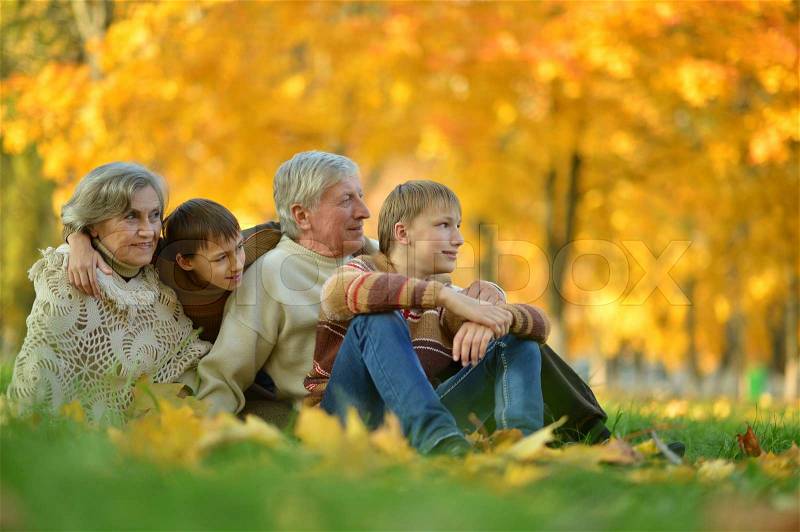 Friendly family together sitting on autumn park grassÐ¼, stock photo
