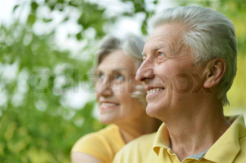Portrait of beautiful old people embracing outdoors on the walk, stock photo
