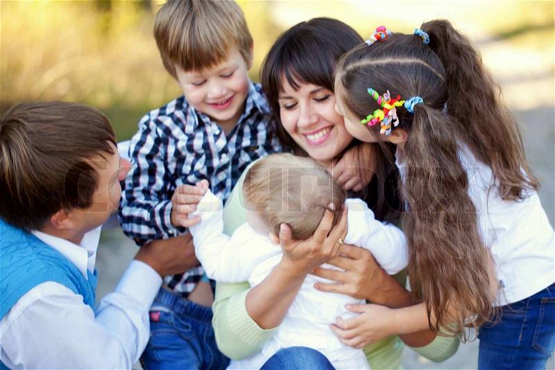 Large family hugging. Father, mother, son, daughter and baby together. Happy family concept, stock photo