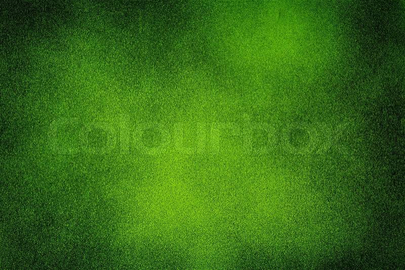 Green dark texture background with bright center spotlight, stock photo