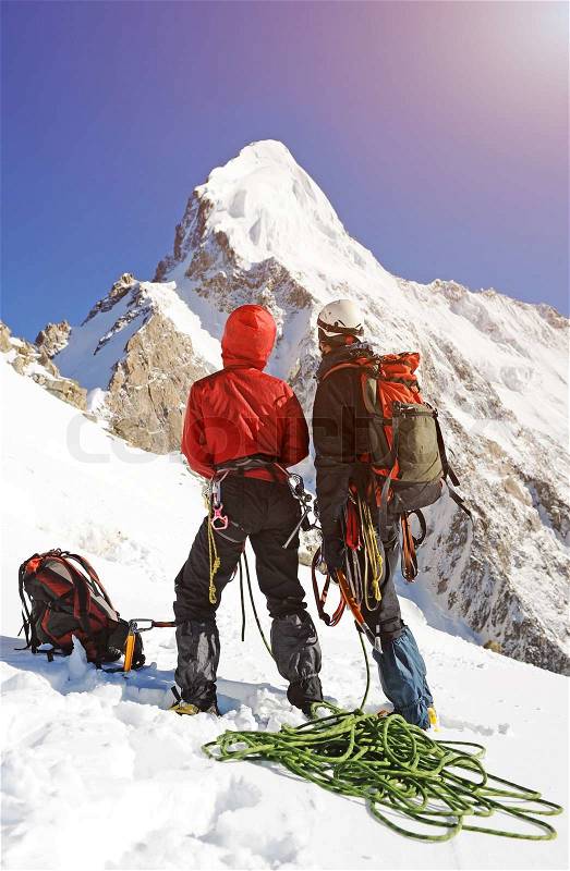 A two climber reaching the summit, stock photo