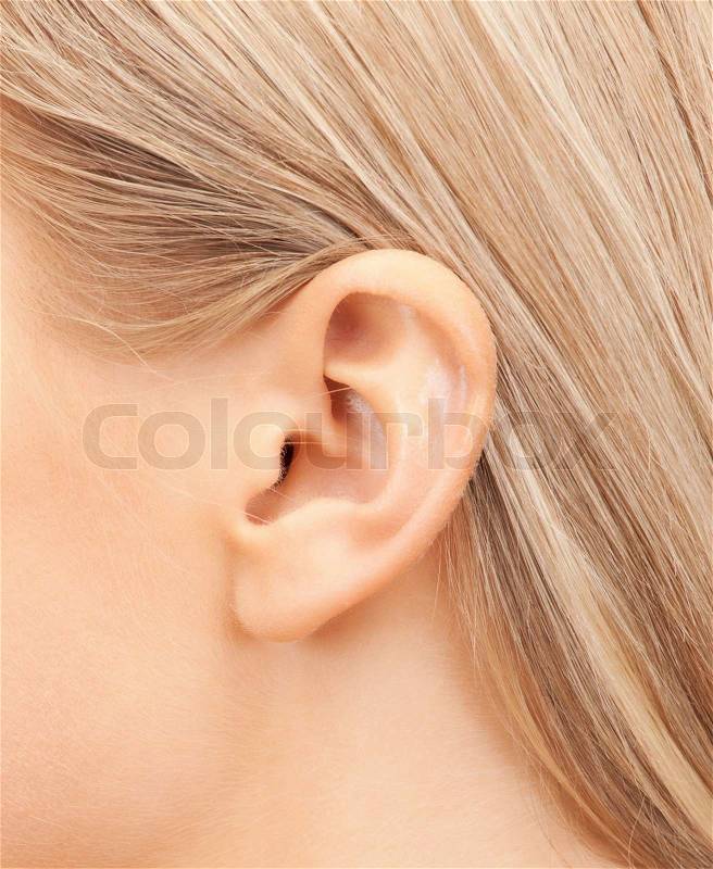 Hearing, health, beauty and piercing concept - close up of woman\'s ear, stock photo