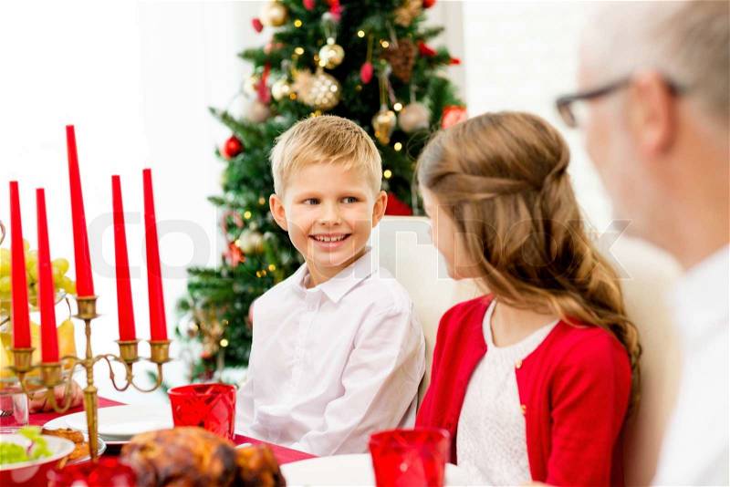Family, holidays, generation, christmas and people concept - smiling family having dinner at home, stock photo