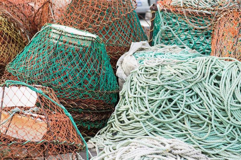Background of fish nets and fishing equipment in green and orange colors, stock photo