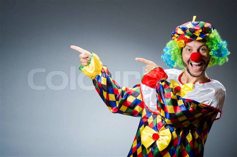 Funny clown in colourful costume, stock photo