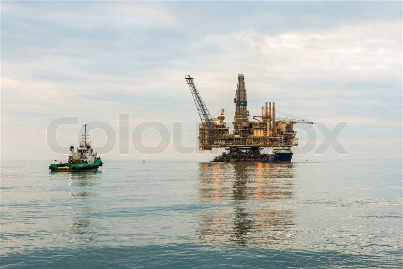 Oil rig platform in the calm sea, stock photo