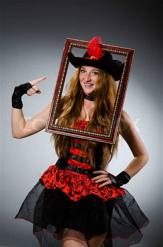 Woman pirate with picture frame, stock photo