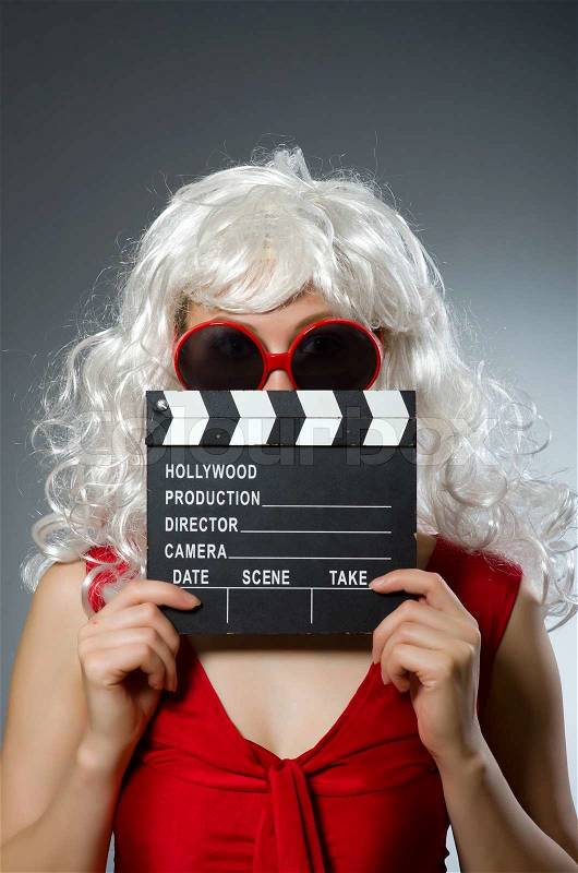 Blond woman with movie board, stock photo