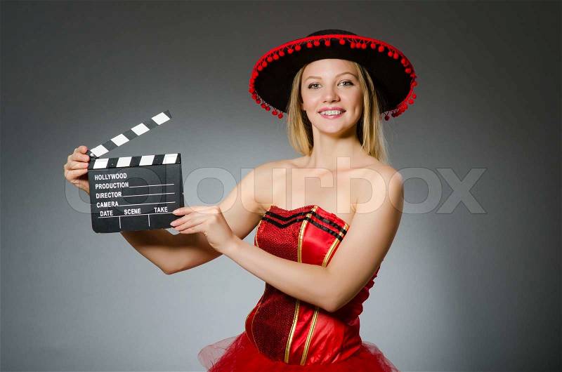 Funny mexican woman with sombrero and movie clapboard, stock photo
