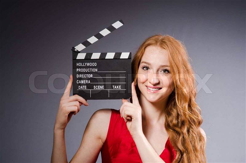 Woman in red dress with movie board, stock photo