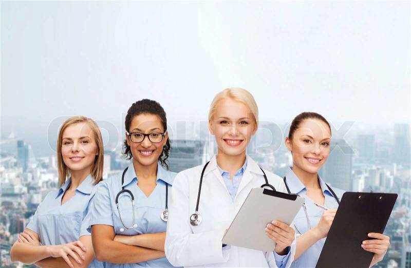 Healthcare and medicine concept - smiling female doctor and nurses with tablet pc, stock photo