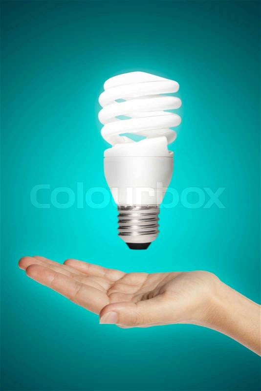 Hand body part with energy saving lamp, stock photo