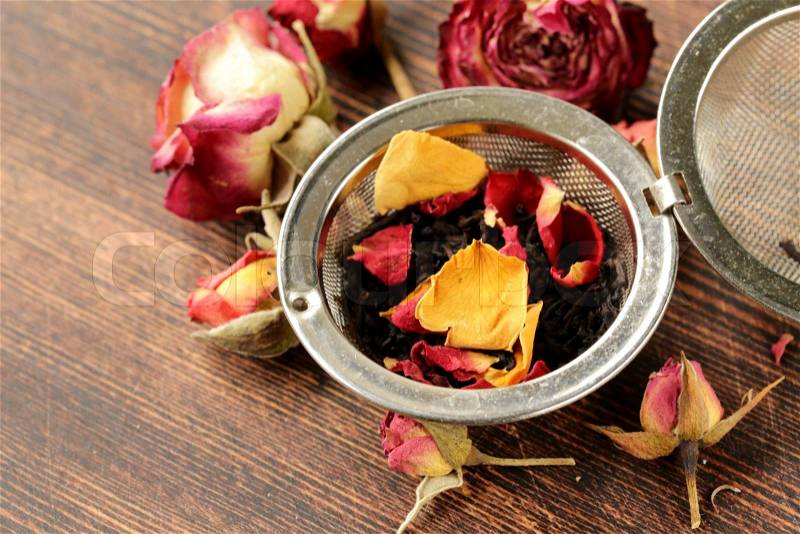 Natural organic tea from dry roses on a wooden background, stock photo