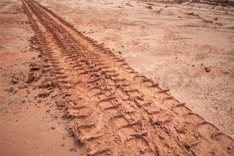 Tire tracks on a muddy road in the countryside, stock photo