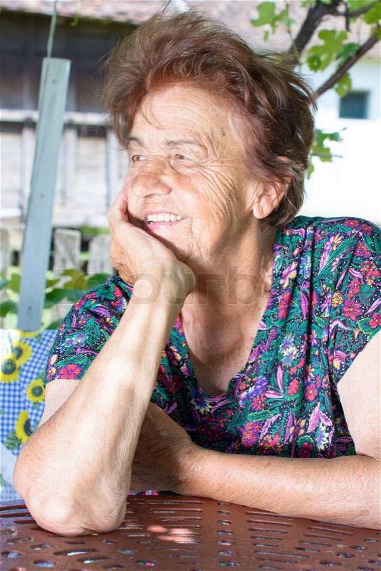 Profile of positive old female with smile on her face, stock photo