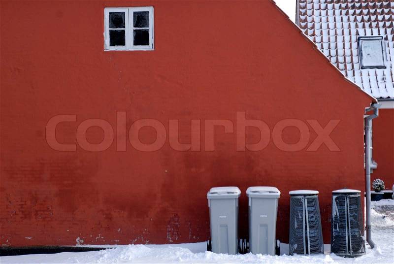 Two garbage bins and two paper recycling bins outside home, stock photo