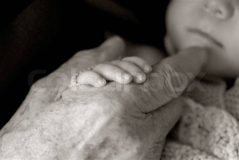 Old hand and new born baby\'s hand, stock photo