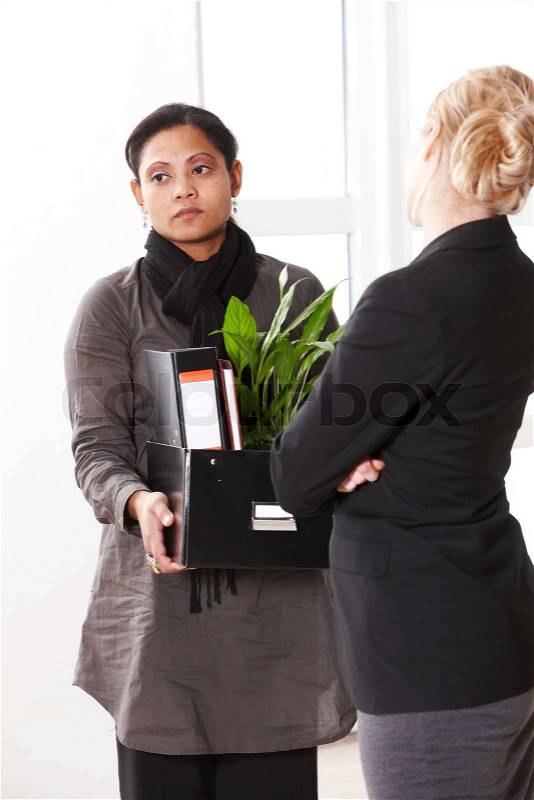 A female office worker who got fired saying goodbye to her colleague, stock photo
