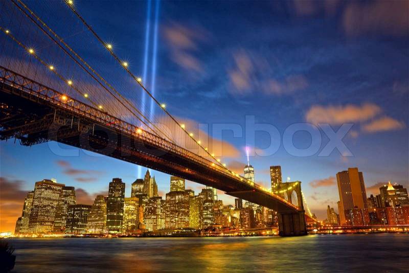 Lower Manhattan skyline with Brooklyn Bridge and the Towers of Lights (Tribute in Light) in New York City, stock photo