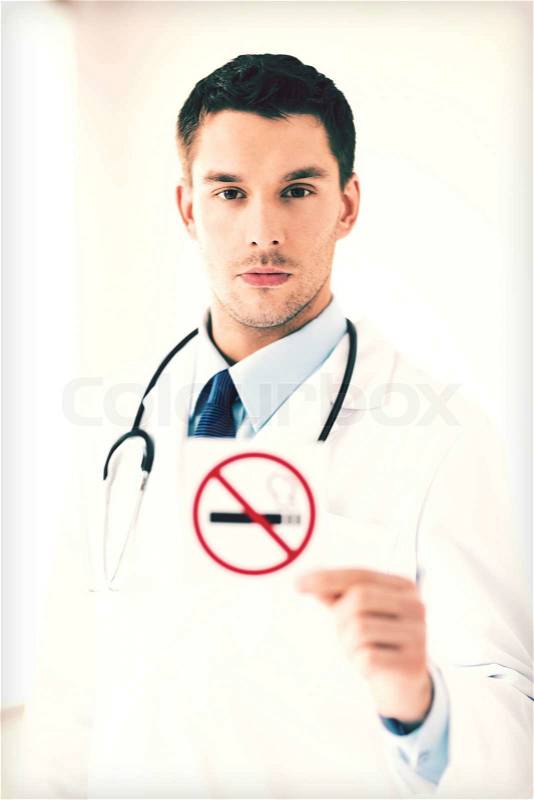 Male doctor holding no smoking sign in hands, stock photo
