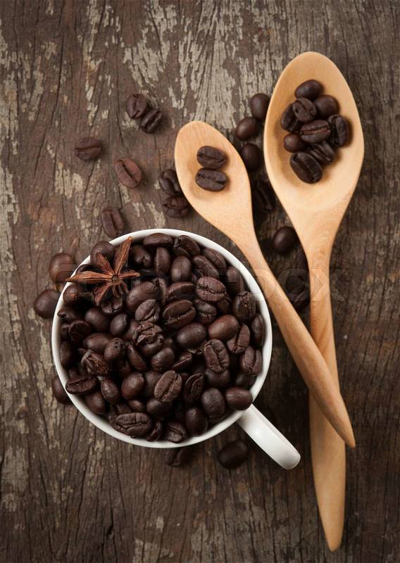 Coffee beans in cup on wood background,selective focus, stock photo