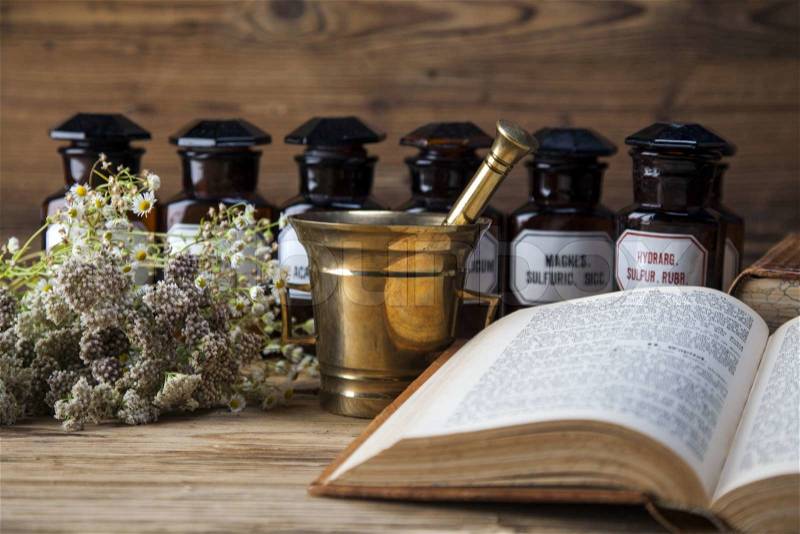 The ancient natural medicine, herbs, medicines and old book, stock photo