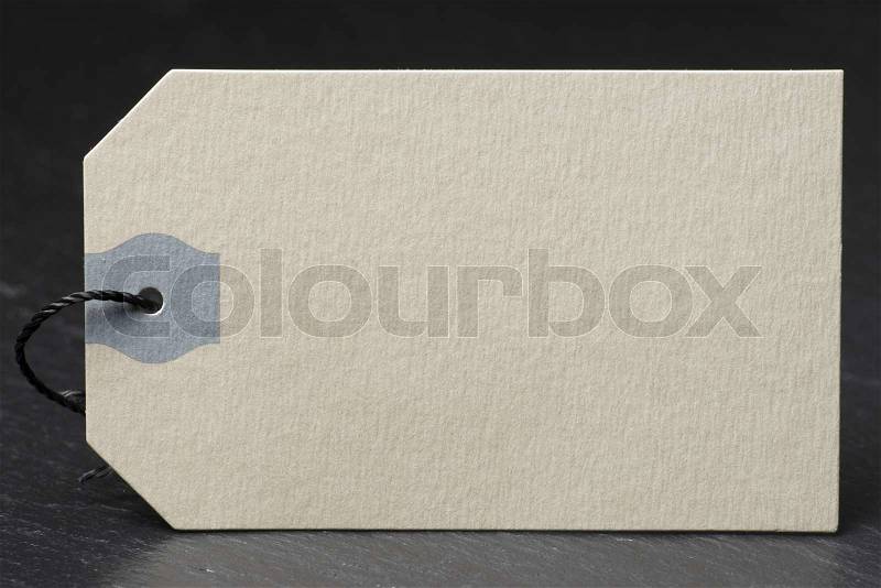 Blank label with twine on a black slate, stock photo